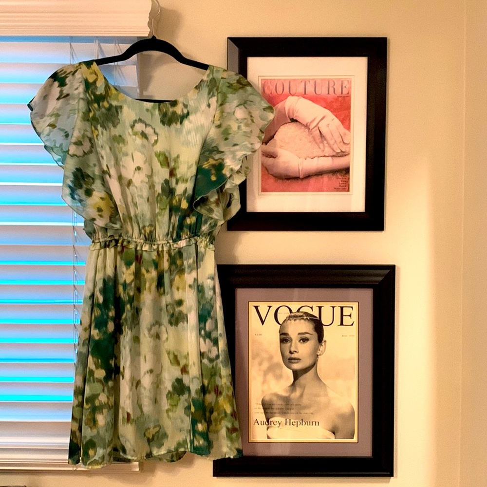 Green floral mini dress with ruffled sleeves.